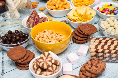 Salty and sweet snacks. Table of salty and sweet snacks. Large group of unhealthy food