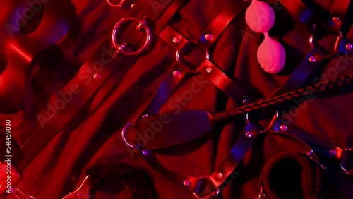 Set of exotic adult sex toys for BDSM sex with submission and domination. Handcuffs, mask, leather whip flogger and female vibrator