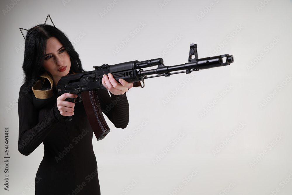 Slender glamour young woman with assault rifle Slender glamour young woman with assault rifle