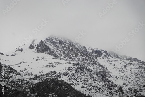 Gray scale of a mountain covered in snow photo