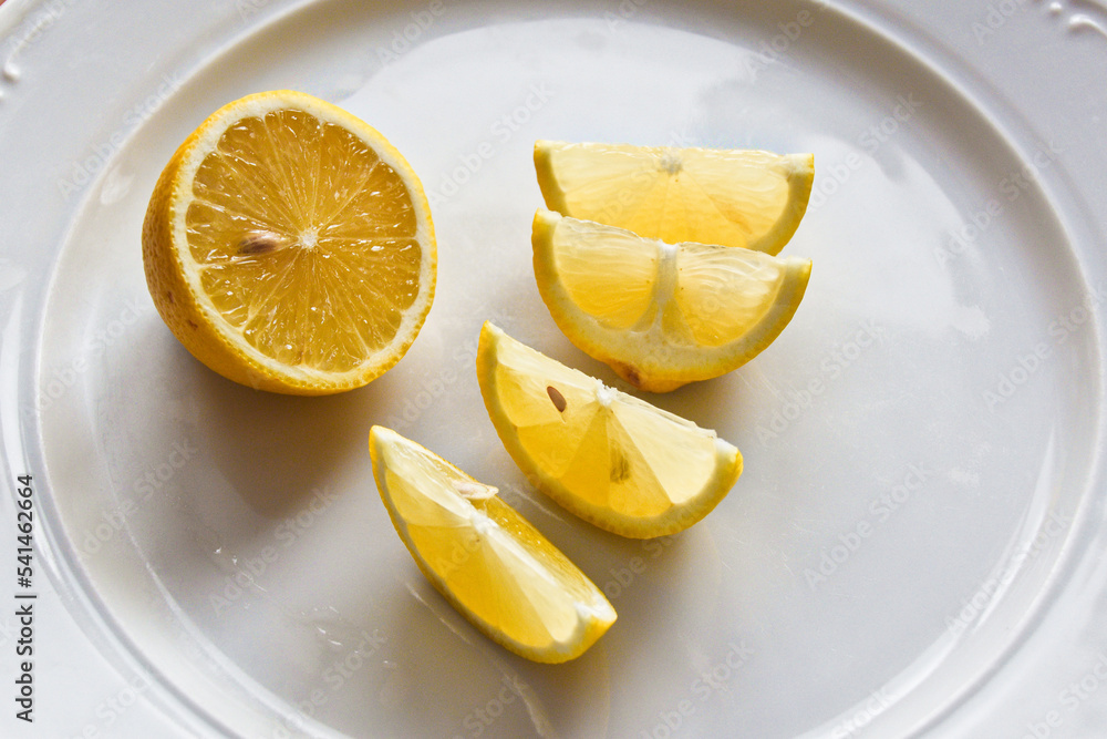 Lemon wedges on the white rural plate Lemon wedges on the white rural plate