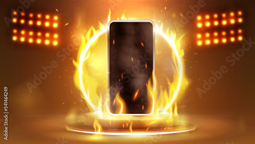 Smartphone in fire on podium with fire ring on background