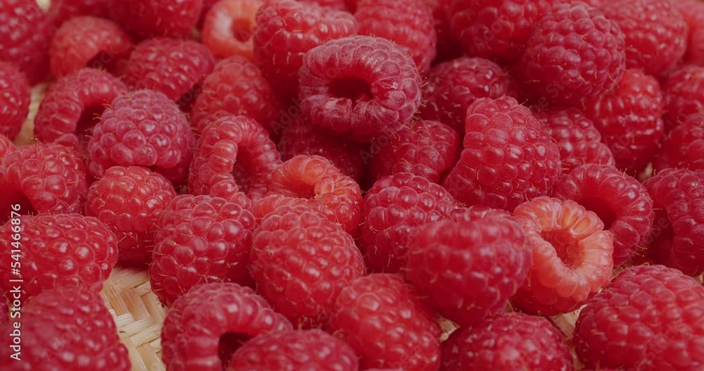 Juicy fresh organic raspberry fruits on basket Juicy fresh organic raspberry fruits on basket