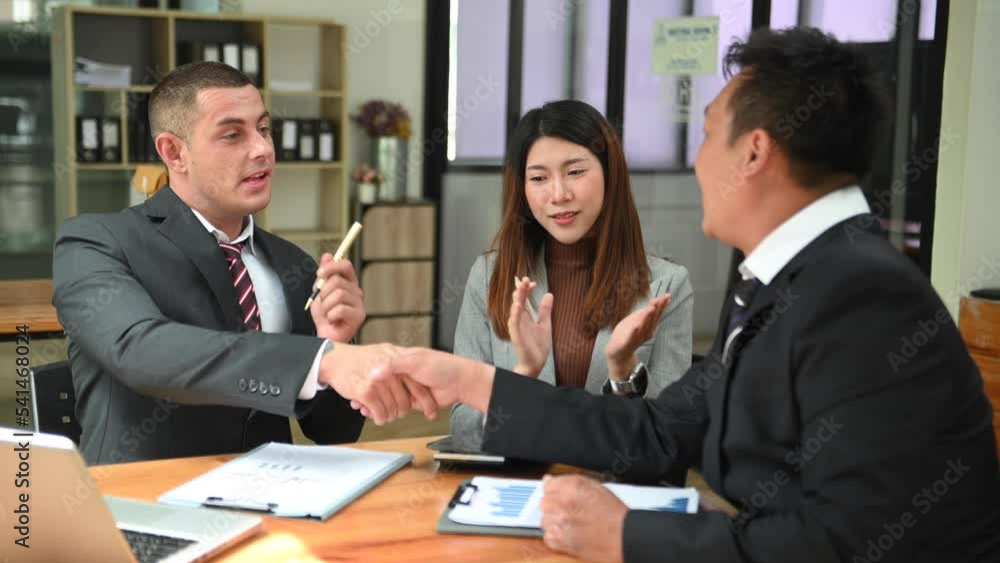 Business people shaking hands during a meeting. Two happy mature business men at office Business people shaking hands during a meeting. Two happy mature business men at office