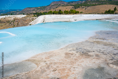 White travertines, calcite cliff of Pamukkale in Turkey photo