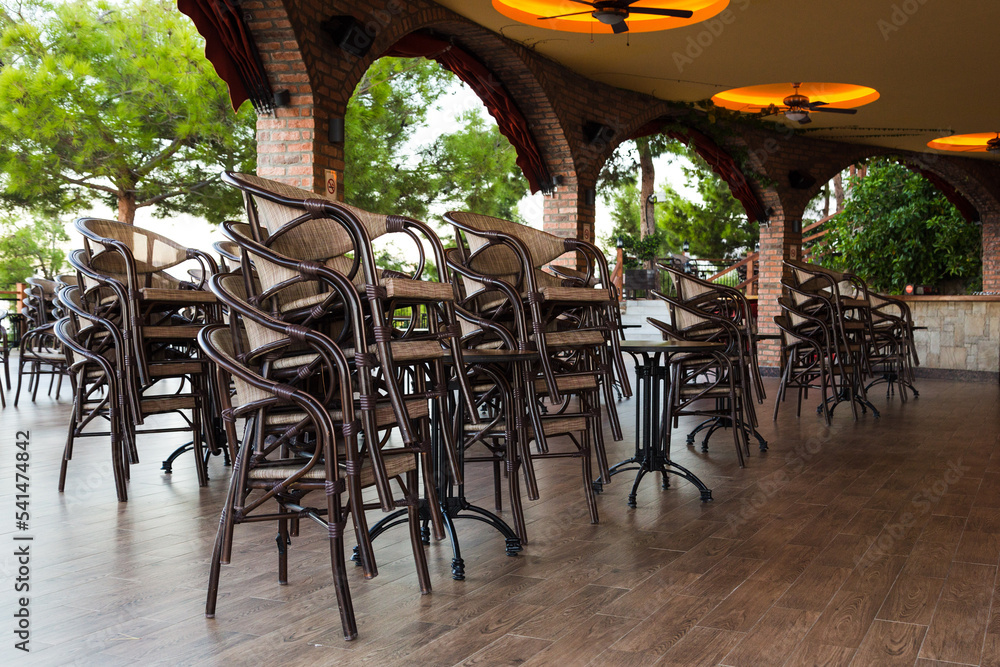 Chairs stacked on top of each other in a cafe near the hotel, preparing for the opening.