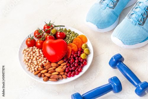Food for heart health with sports fitness equipment. Healthy nutrition eating