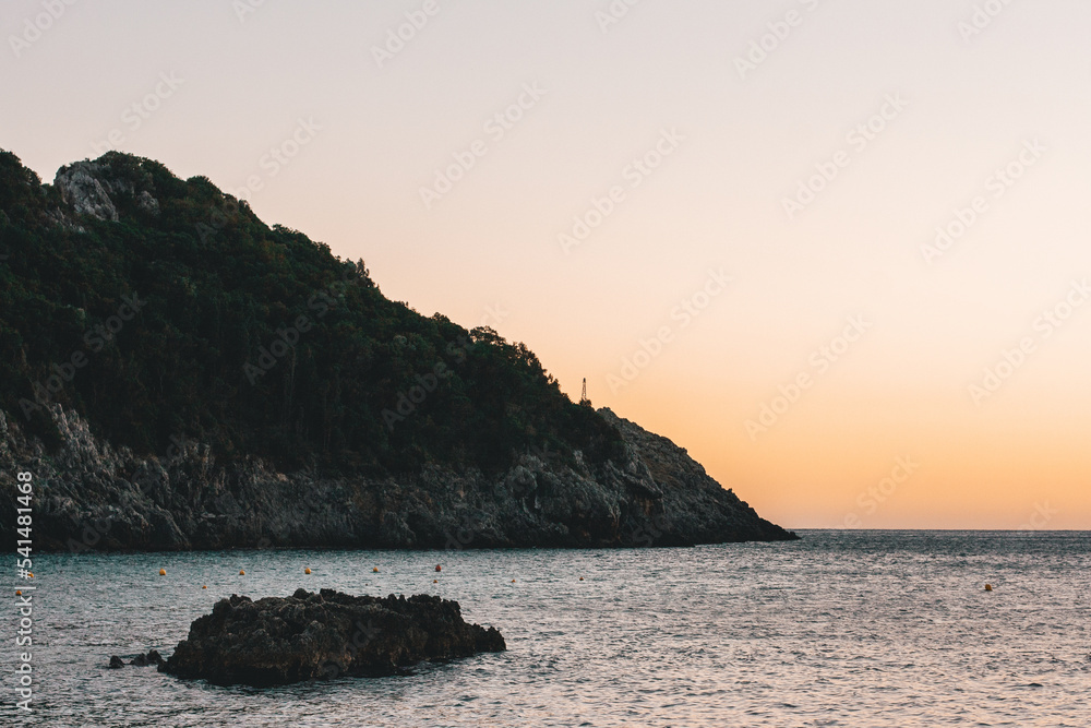 Corfu, Greece.Beautiful landscape with a huge rock in the water at sunset.
