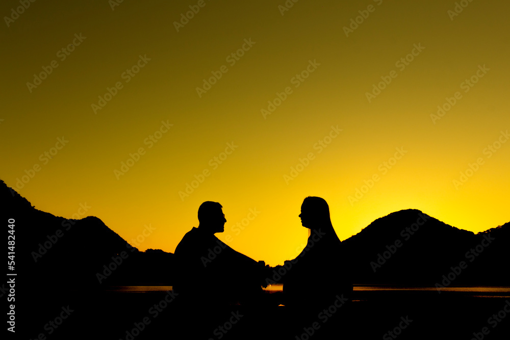 silhouette of a couple on the lagoon