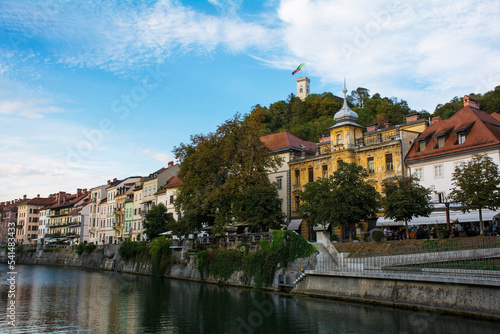 Historic buildings on the waterfront of the Ljubljanici River in central Ljubljana, Slovenia. The castle tower is seen on Castle Hill on the background 