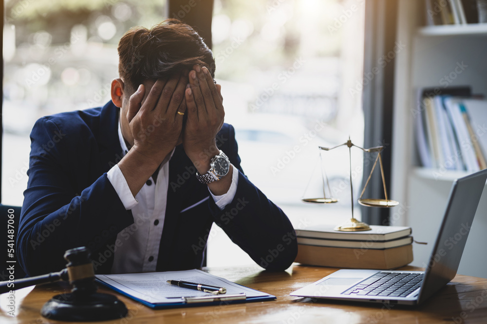 A lawyer or businessman is stressed about losing a lawsuit and going bankrupt. A lawyer or businessman is stressed about losing a lawsuit and going bankrupt.