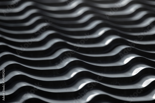 Gray metal roof tiling with wavy shape pattern, close up photo