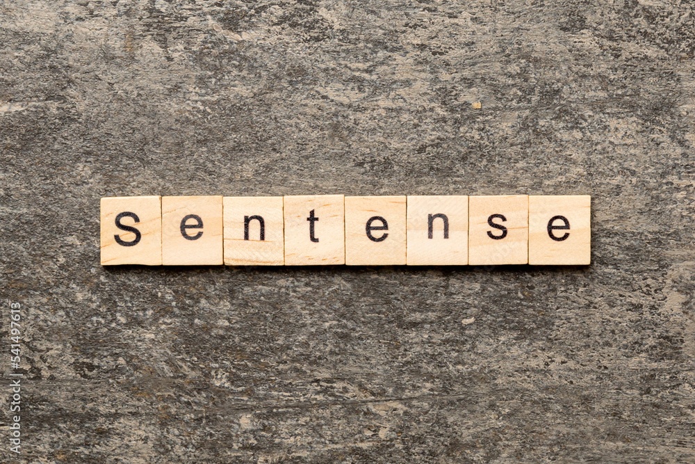 Sentence word written on wood block. Sentence text on table, concept