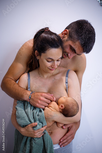 Embracing family with newborn baby photo