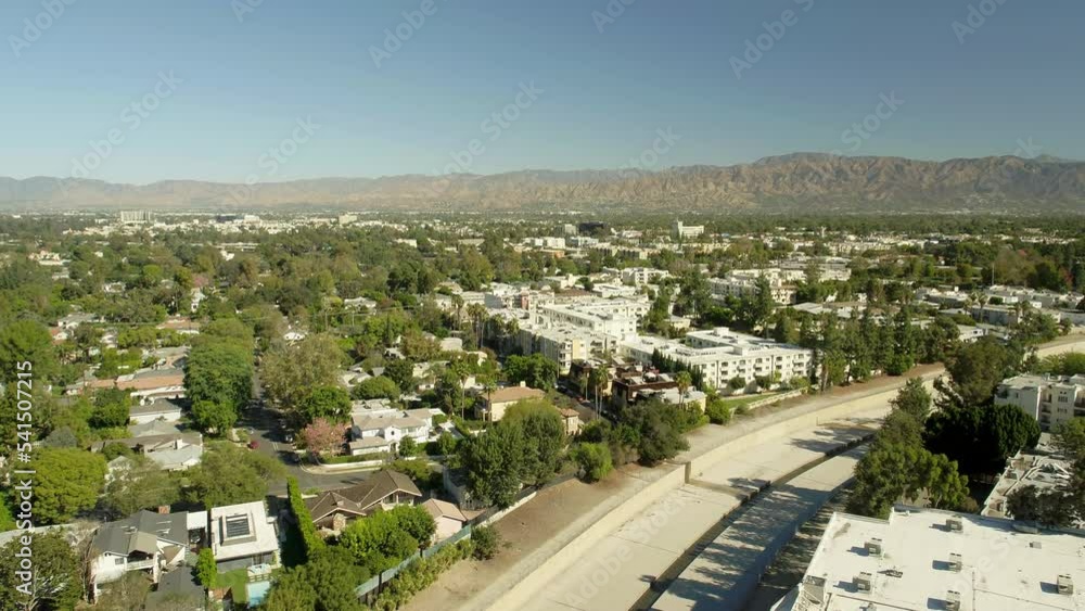 Aerial Forward Shot Of Residential Houses And Buildings In City By Mountains On Sunny Day - Los Angeles, California Aerial Forward Shot Of Residential Houses And Buildings In City By Mountains On Sunny Day - Los Angeles, California
