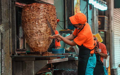 Mexican taquero working doing tacos	
