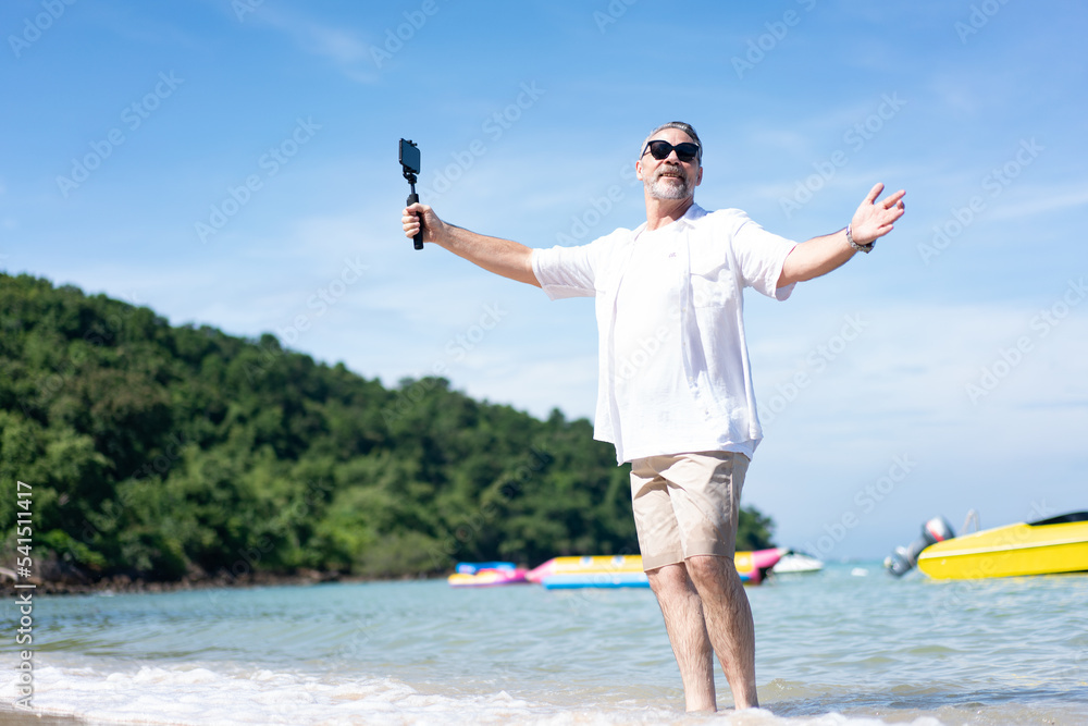 Man taking selfie of himself after workout. Good looking taking a self-portrait picture with his smartphone camera on a beach during summer vacation travel. Man taking selfie of himself after workout. Good looking taking a self-portrait picture with his smartphone camera on a beach during summer vacation travel.