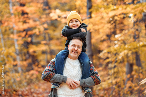Happy men with adopted child on autumn season
