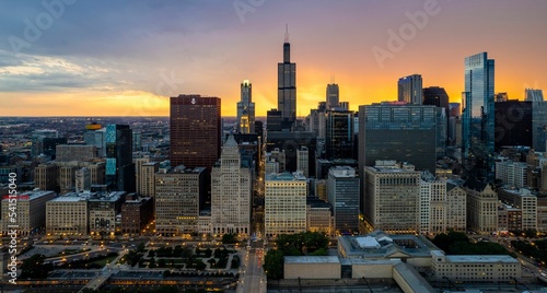 Aerial view of Chicago Downtown with high skyscrapers at sunset in cloudy sky background