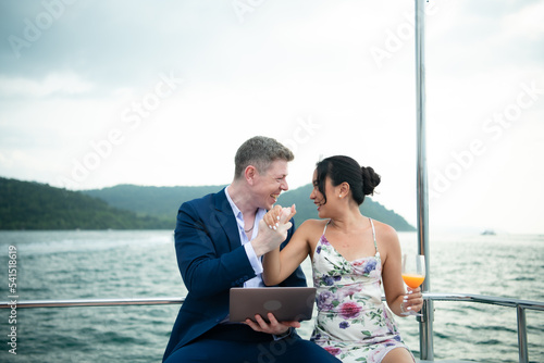 On a yacht, a businessman begins his family's vacation. a huge project agreement was successfully closed, © Wosunan
