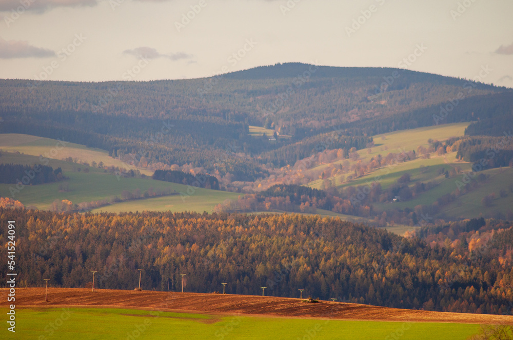 beautiful calm landscape. overlooking hills fields and forests under a cloudy sky