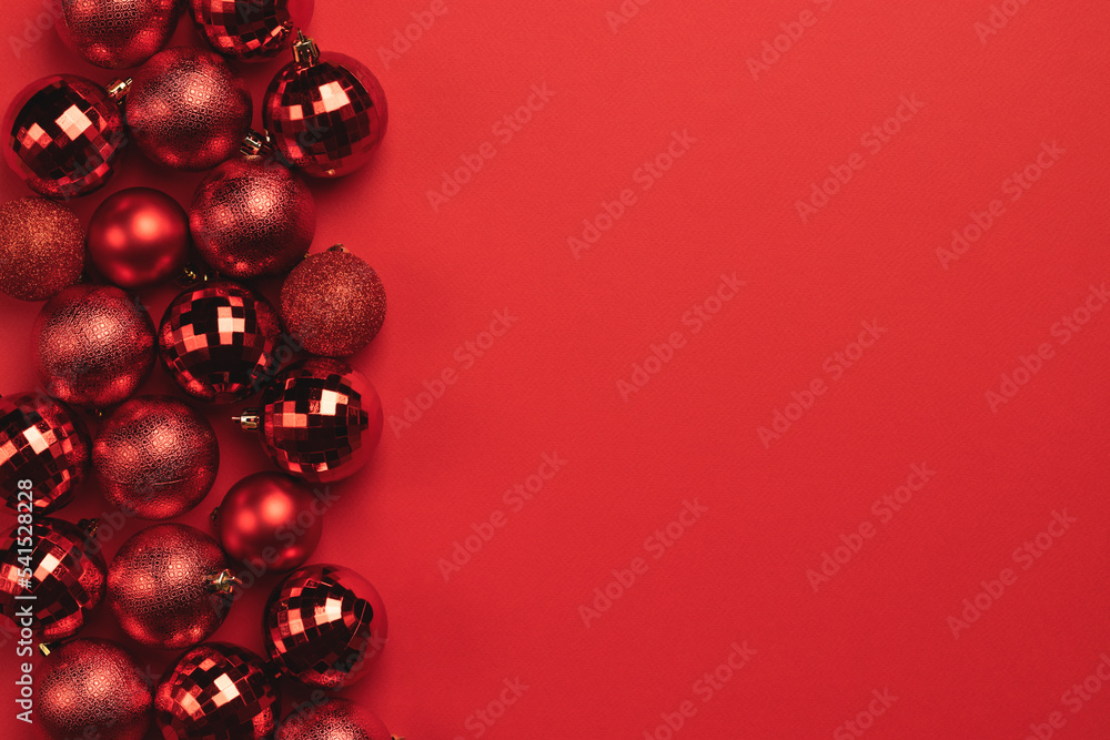 Christmas card with red glitter bauble balls on red background with copy space Christmas card with red glitter bauble balls on red background with copy space