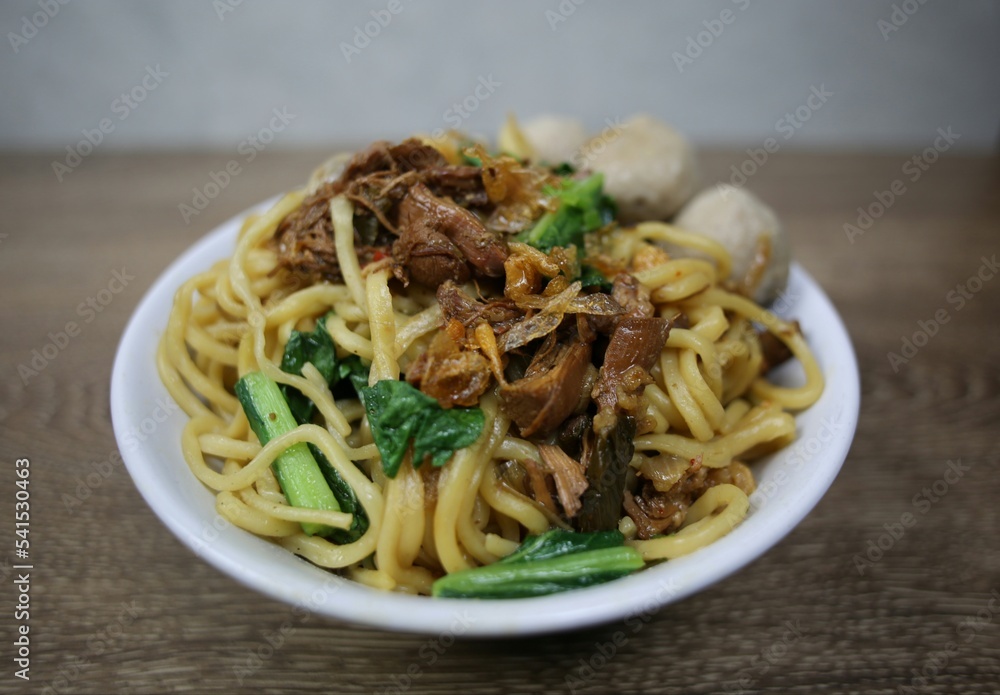 Indonesian street food. Chicken noodles in a bowl. Top view.