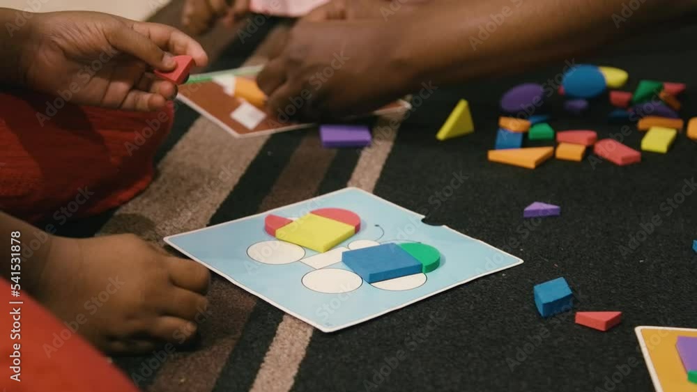 Young Black children, Black girls, Black boy, and Black infant baby playing with building blocks, toys, and train sets Young Black children, Black girls, Black boy, and Black infant baby playing with building blocks, toys, and train sets