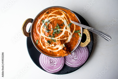 Butter Chicken karahi or chicken makhni with onion and chili served in a dish isolated on grey background top view of bangladesh food