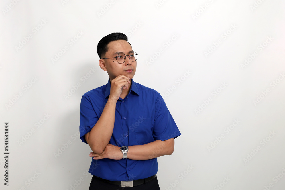 Young asian man standing while looking sideways at blank space. Isolated on white background with copyspace Young asian man standing while looking sideways at blank space. Isolated on white background with copyspace