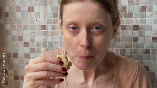 Young woman eating cookies at home interior
