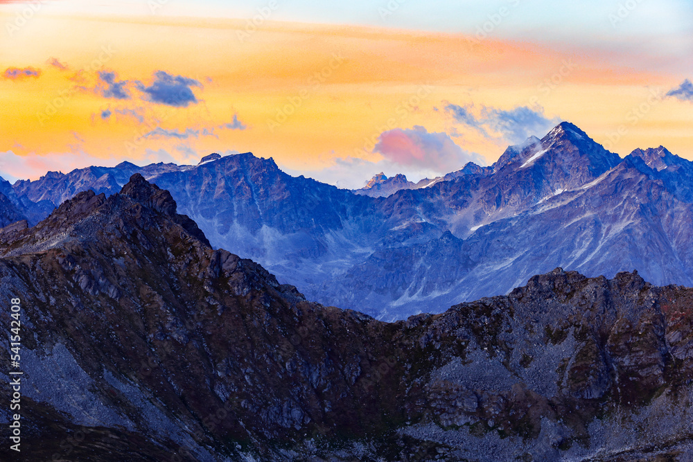 Mountain Range in Hatcher's Pass Alaska with orange sunset and clouds