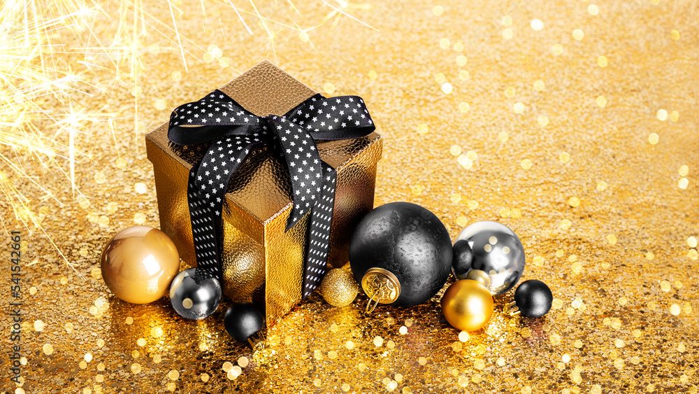 Merry Christmas and Happy New Year! Gift in a golden box with a bow and ...