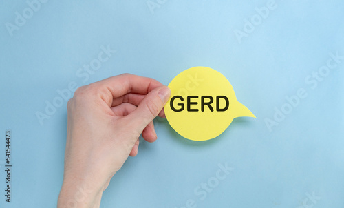 word GERD written in hand on a yellow piece of paper.