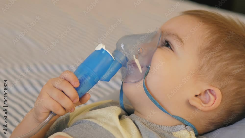 Child Inhaler Mask Little 2 years old boy does therapeutic inhalation using a nebulizer ...