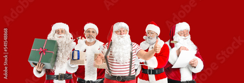 Many Santa Clauses on red b...