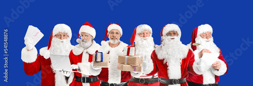Many Santa Clauses on blue ...