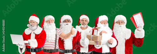 Many Santa Clauses on green...