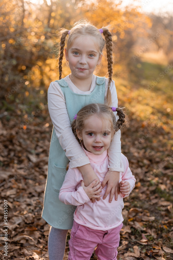 children walk, play, socialize and have fun in the autumn park on a warm sunny day, lifestyle