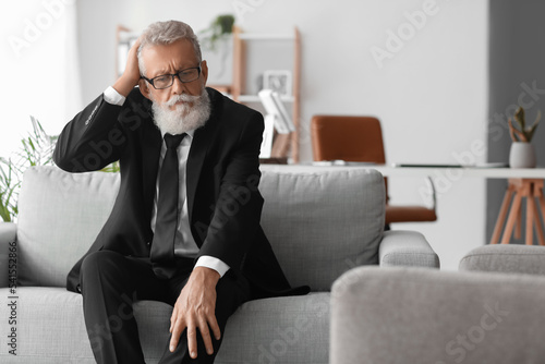 Thoughtful mature man sitti...