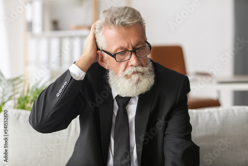 Thoughtful mature man sitti...
