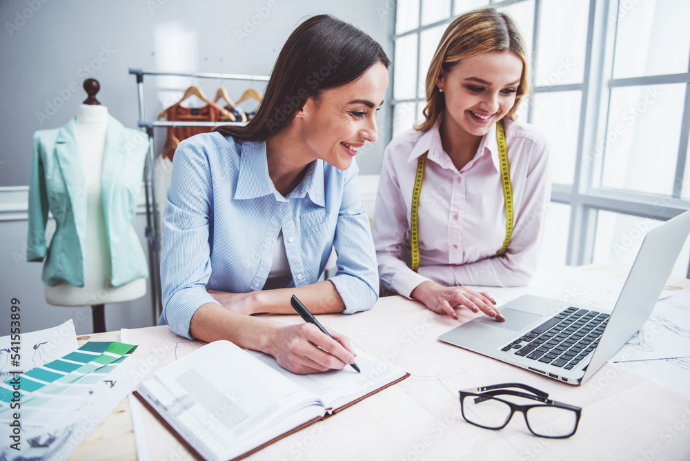 Fototapeta premium Beautiful designers working with gadget