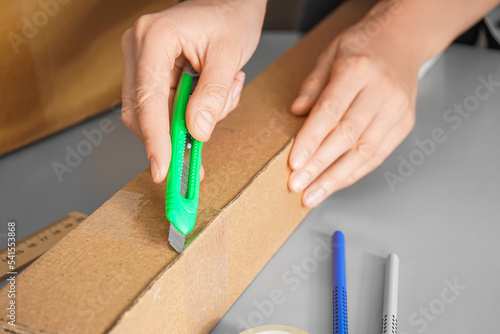 Man opening cardboard box w...