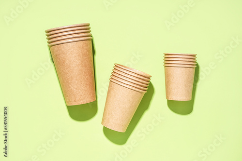 Paper cups on green background