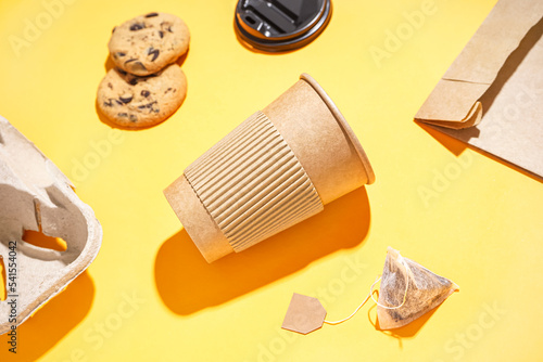 Paper cup and tea bag on co...
