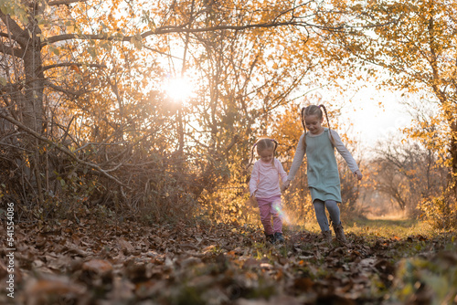 children walk, play, socialize and have fun in the autumn park on a warm sunny day, lifestyle © КРИСТИНА Игумнова
