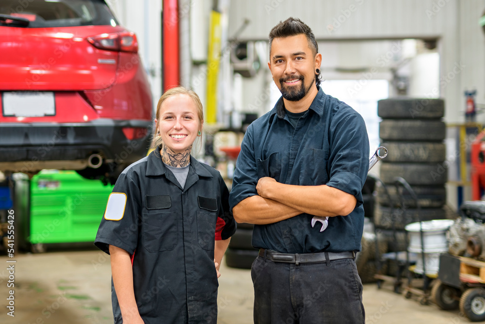 Two Handsome mechanic worker in uniform worker Two Handsome mechanic worker in uniform worker