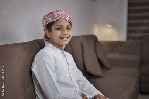 Young Indian Muslim Boy Smiling Wearing Arabic Clothes photo