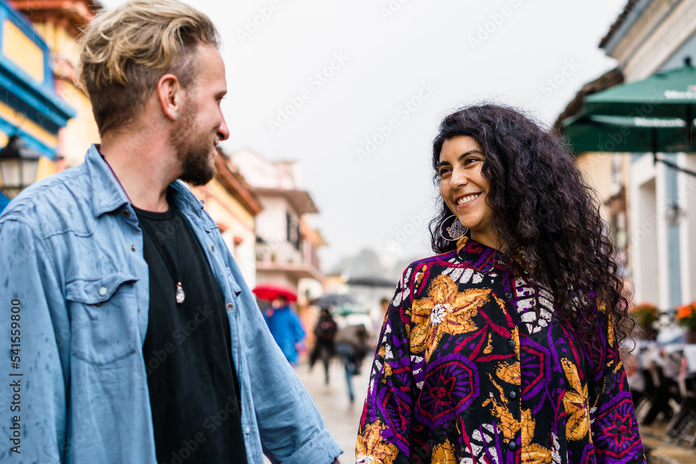 Caucasian man looking at his latina friend smiling. Caucasian man looking at his latina friend smiling.