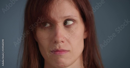 Woman blowing on annoyed long forelock, close-up view